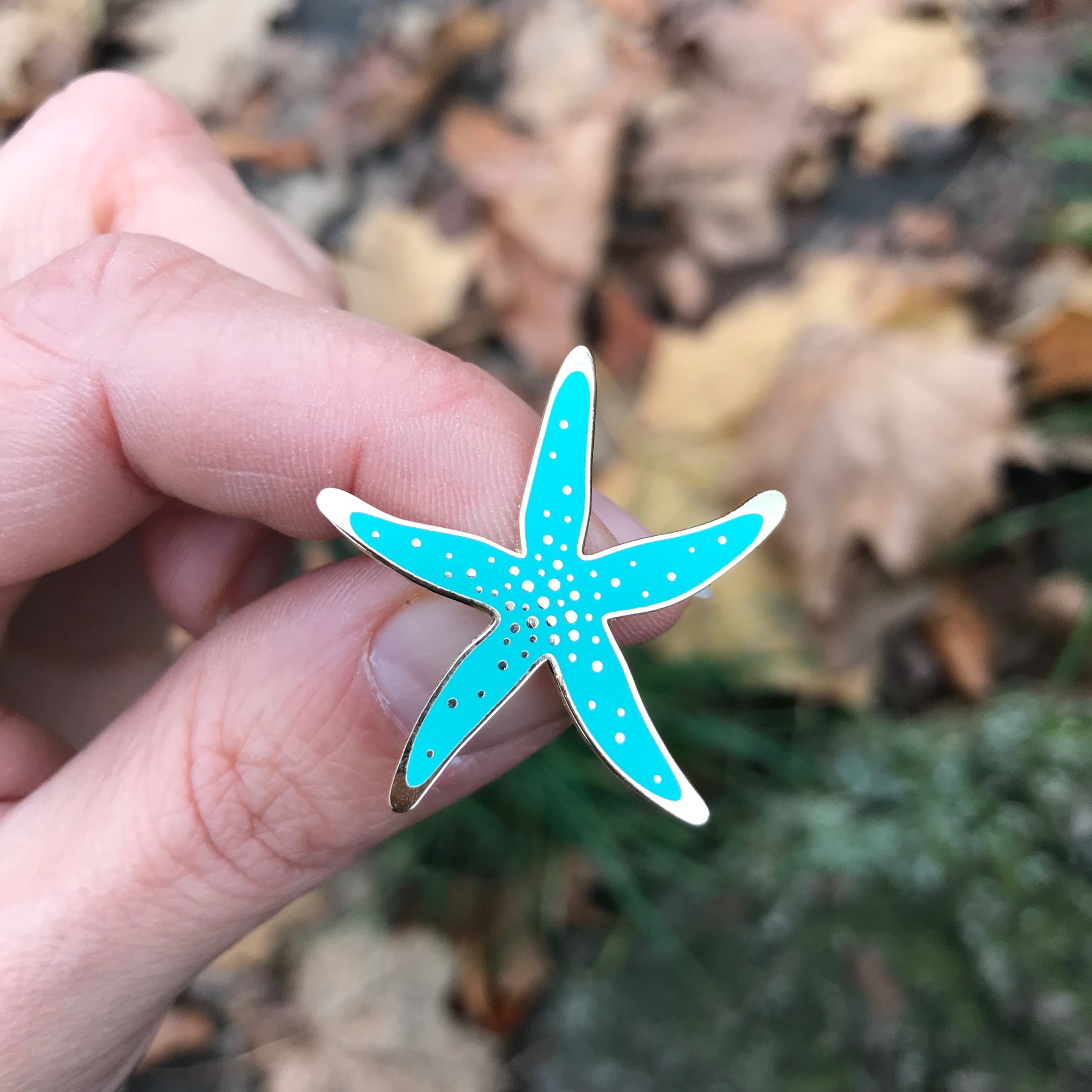 A starfish hard enamel pin